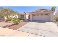 Charming single-story home with a well-maintained desert-style front yard and attached two-car garage at 2456 Desert Sands Dr, Las Vegas, NV 89134