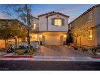 Charming two-story home with a two-car garage and brick-paved driveway, nicely landscaped at 27 Parco Fiore Ct, Henderson, NV 89011