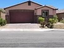Charming single-story home with stone accents, a two-car garage, and low-maintenance landscaping at 2748 Brinkley Manor St, Laughlin, NV 89029