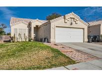 Charming home featuring a two-car garage, front lawn, and a quaint, tiled entryway at 3622 Covewick Dr, North Las Vegas, NV 89032