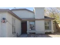Charming single-story home with a chimney and protective window bars at 3711 Southern Light Dr, Las Vegas, NV 89115