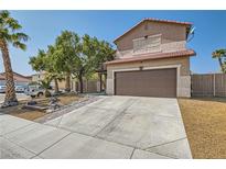 Two-story home featuring a well-maintained front yard, mature trees, a driveway, and an attached two-car garage at 6031 Colonial Oak Ct, North Las Vegas, NV 89031