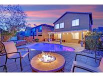Inviting backyard features a pool, hot tub, fire pit, and covered patio ideal for entertaining at 765 Crimson Peak Pl, Henderson, NV 89011