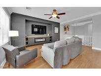 Inviting living room featuring a cozy fireplace, custom built-ins, and an open floor plan at 765 Crimson Peak Pl, Henderson, NV 89011