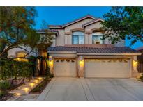 Charming two-story home featuring a three-car garage and a beautifully landscaped front yard at 812 Eaglewood Dr, Las Vegas, NV 89144