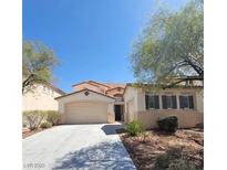 Charming single-Gathering home with a well-maintained lawn and a spacious driveway with an attached two-car garage at 1540 Sabatini Dr, Henderson, NV 89052