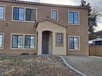 Two story tan home with stucco, many windows and a covered front porch at 2011 Sue Ct # 203, Las Vegas, NV 89108