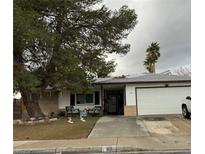 Charming single story home with a two car garage and large shade tree in the front yard at 212 Bradshaw Way, Las Vegas, NV 89145