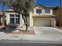 Charming two-story home featuring a tile roof, attached garage, and well-maintained landscaping at 2606 Heartland Ave, Henderson, NV 89074