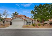 Charming home with a two-car garage, landscaped front yard, and a classic southwestern-style roof at 345 Templeton Dr, Henderson, NV 89074