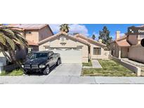 Charming single-story home featuring a two-car garage, desert landscaping, and a welcoming entrance at 4536 Toadstool Ln, Las Vegas, NV 89110
