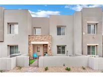 Stylish townhouse with a stone accent wall and a cozy front patio with seating at 600 N Carriage Hill Dr # 1008, Las Vegas, NV 89138