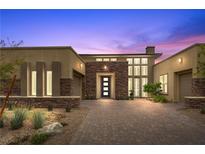 Stunning home featuring a modern elevation, a stone facade, with desert landscaping at 6700 Regency Stone Way, Las Vegas, NV 89148