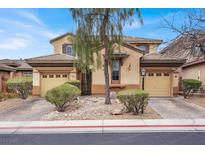 Charming two-story home featuring a dual garage, desert landscaping, and a welcoming facade with neutral color palette at 9049 Teetering Rock Ave, Las Vegas, NV 89143