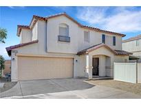 Two-story home featuring stucco siding, a two-car garage, and a well-manicured front yard at 9073 Spoonbill Ridge Pl, Las Vegas, NV 89143