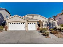 Single-story home featuring a three-car garage, neutral stucco exterior, and manicured landscaping at 9632 Cherry Canyon Ave, Las Vegas, NV 89129