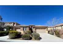 Charming single-story home with a well-manicured front yard and a three-car garage at 9812 Turtle Walk Ave, Las Vegas, NV 89149