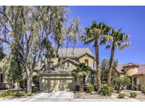 Charming two-story home featuring desert landscaping, palm trees, and a spacious two-car garage at 11215 Piazzale St, Las Vegas, NV 89141