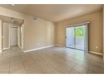 Inviting living room with sliding glass doors and neutral tile flooring at 2615 W Gary Ave # 2051, Las Vegas, NV 89123