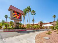 Community entrance showcasing the 'Bella Vita' sign with palm trees and a well maintained landscape at 5339 Indian River Dr # 281, Las Vegas, NV 89103
