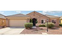 Charming single-story home featuring a tile roof, arched entryway, and low-maintenance desert landscaping at 5521 Little Lake Ave, Las Vegas, NV 89122