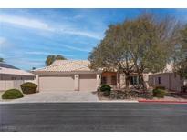 Charming single-story home featuring a neutral color palette, mature trees, and a two-car garage at 6032 Port Of Dreams Dr, Las Vegas, NV 89130