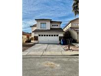 Two-story stucco house with a two car garage and stone accents on the front at 7977 Blue Brook Dr, Las Vegas, NV 89147