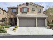 Charming two-story home with a three-car garage and stone accents at 8088 Smoking Jacket Pl, Las Vegas, NV 89166