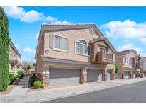 Charming two-story home with attached two-car garage, balcony and landscaped front yard at 8658 Tom Noon Ave # 103, Las Vegas, NV 89178
