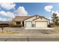Charming single-story home with a two-car garage and desert landscaping at 1131 S Blagg Rd, Pahrump, NV 89048
