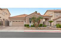 Charming single-story home with a two-car garage, desert landscaping and tile roof at 1303 Panini Dr, Henderson, NV 89052