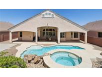 Inviting backyard with a uniquely shaped pool and a relaxing spa, perfect for outdoor entertainment at 2197 Big Bar Dr, Henderson, NV 89052
