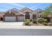 Charming single-story home featuring a three-car garage and manicured landscaping at 2197 Big Bar Dr, Henderson, NV 89052
