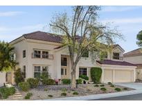Charming two-story home with a tile roof, lush landscaping, and a two-car garage at 2636 Ontario Dr, Las Vegas, NV 89128