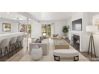 Bright living room with modern furniture, fireplace, and sliding glass doors to the outdoor area at 2935 Pinehurst Dr, Las Vegas, NV 89109