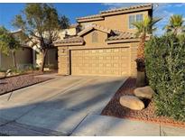 Charming home featuring a spacious two-car garage with a landscaped front yard at 4454 Bertram Ln, Las Vegas, NV 89147