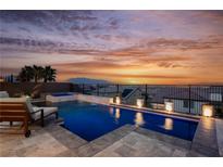 Beautiful pool and spa at sunset with lounge chairs and landscaped planters at 4576 Amazing View St, Las Vegas, NV 89129