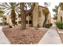 Beautiful condo exterior with desert landscaping, mature trees, and convenient walkway access at 4742 Obannon Dr # D, Las Vegas, NV 89102