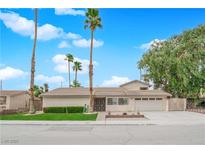 Charming single-story home with desert landscaping, lush lawn, and a spacious two-car garage at 5239 Somerset Dr, Las Vegas, NV 89120
