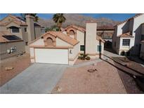 Charming single-Gathering home featuring a two-car garage and desert landscaping at 566 Searchlight Dr, Las Vegas, NV 89110