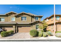 Attractive two-story home with a paved driveway, two-car garage and manicured front yard landscaping at 5697 Garriga Dr, Las Vegas, NV 89135