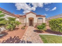 Charming single-story home featuring a landscaped yard, and inviting front entry with a paver walkway at 7860 Villa Del Fuego, Las Vegas, NV 89131