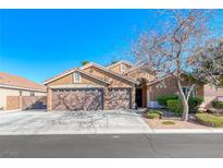 Charming single-story home with a three-car garage and well-maintained landscaping on a sunny day at 8348 Mountain Destiny Ave, Las Vegas, NV 89131