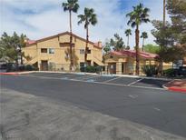 Inviting building exterior showcases well-maintained landscaping, ample parking, and mature palm trees at 900 Heavenly Hills Ct # 219, Las Vegas, NV 89145