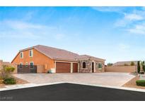 A charming single-story home boasts a three car garage, desert landscaping and a beautiful mediterranean facade at 9096 Becket Ranch Ct, Las Vegas, NV 89113