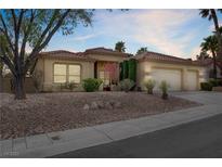 Charming single-story home with a desert landscape and a three-car garage, set against a beautiful dusk sky at 10201 Los Padres Pl, Las Vegas, NV 89134