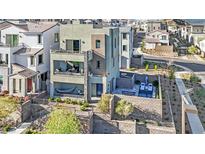 Stylish three-story home featuring private balconies, a courtyard with a hammock, and a backyard pool at 11598 Kindle Corner Ave, Las Vegas, NV 89138