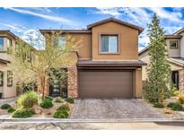 Charming two-story home featuring desert landscaping and a two car garage at 12401 Ferry Glide Ave, Las Vegas, NV 89138