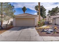 Charming single-story home featuring a two-car garage and desert landscaping at 1709 Autumn Rust Dr, Las Vegas, NV 89119
