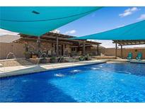 Inviting backyard pool with lush landscaping, water features, and shaded lounge areas at 1988 N Moapa Valley Blvd, Logandale, NV 89021